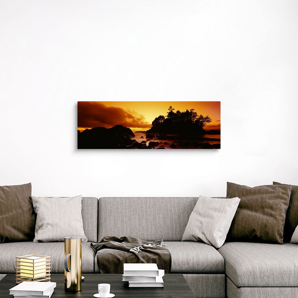 A traditional room featuring Panoramic photograph displays a sunburnt sky as the sun begins to set over the profile of a rocky...