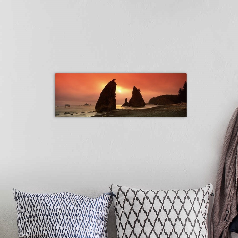 A bohemian room featuring This is a panoramic photograph of the sun setting behind enormous rock formations on this rocky N...