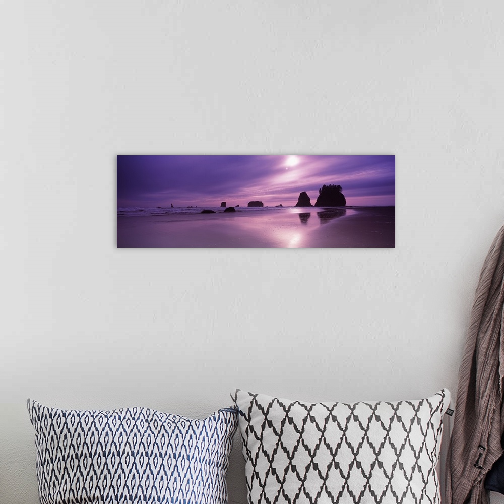 A bohemian room featuring Panoramic photograph taken from a beach with silhouettes of rock formations in the distance as th...