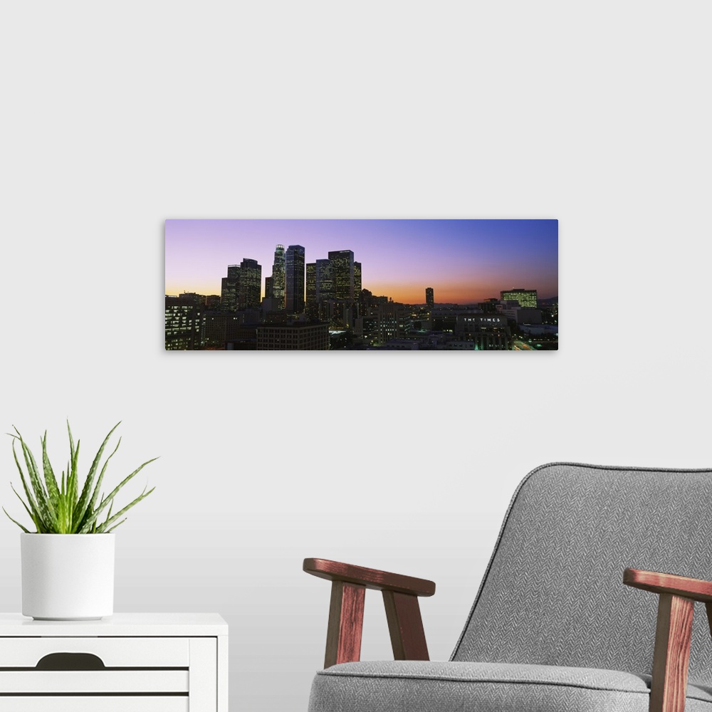 A modern room featuring Silhouette of skyscrapers at dusk, City of Los Angeles, California