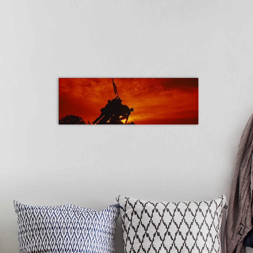 A bohemian room featuring Big, panoramic photograph of the silhouette of the Iwo Jima Memorial, against a fiery sunset in  ...