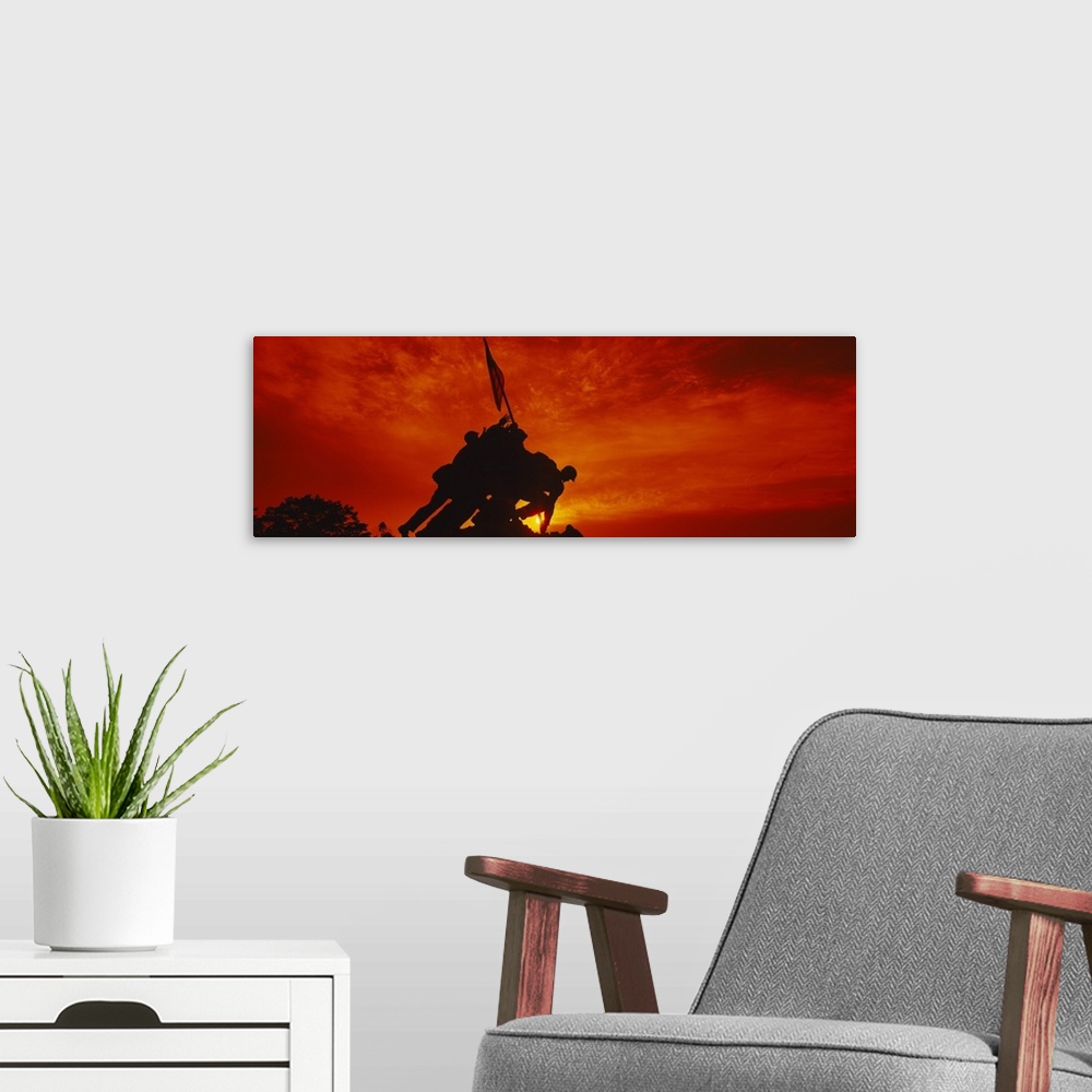 A modern room featuring Big, panoramic photograph of the silhouette of the Iwo Jima Memorial, against a fiery sunset in  ...
