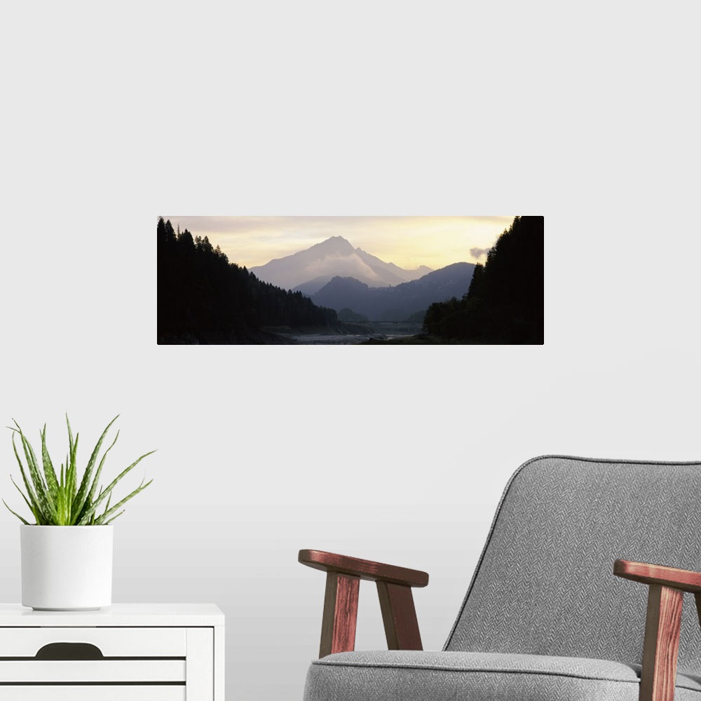 A modern room featuring Silhouette of trees with a mountain range in the background, Dolomites, Cadore, Province of Bellu...