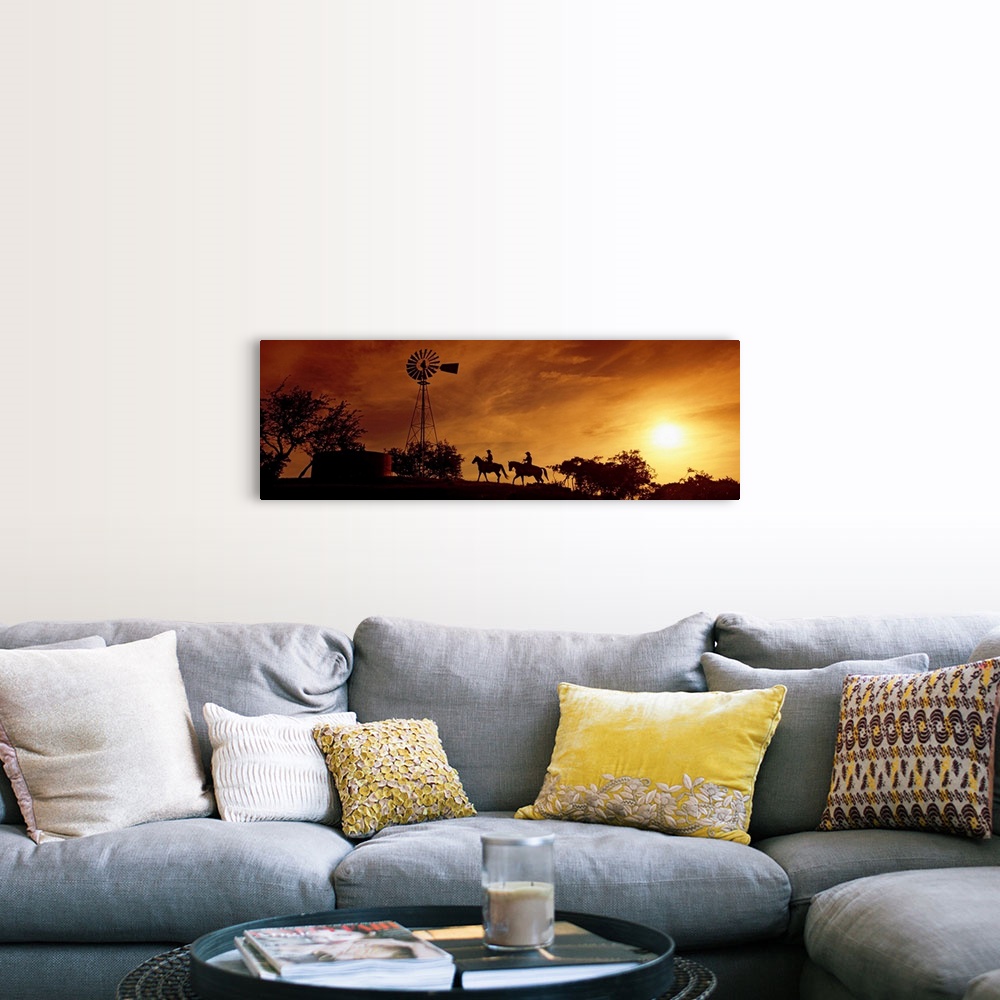 A farmhouse room featuring Landscape, panoramic artwork of a hill with a windmill perched at the top on a farm at twilight.