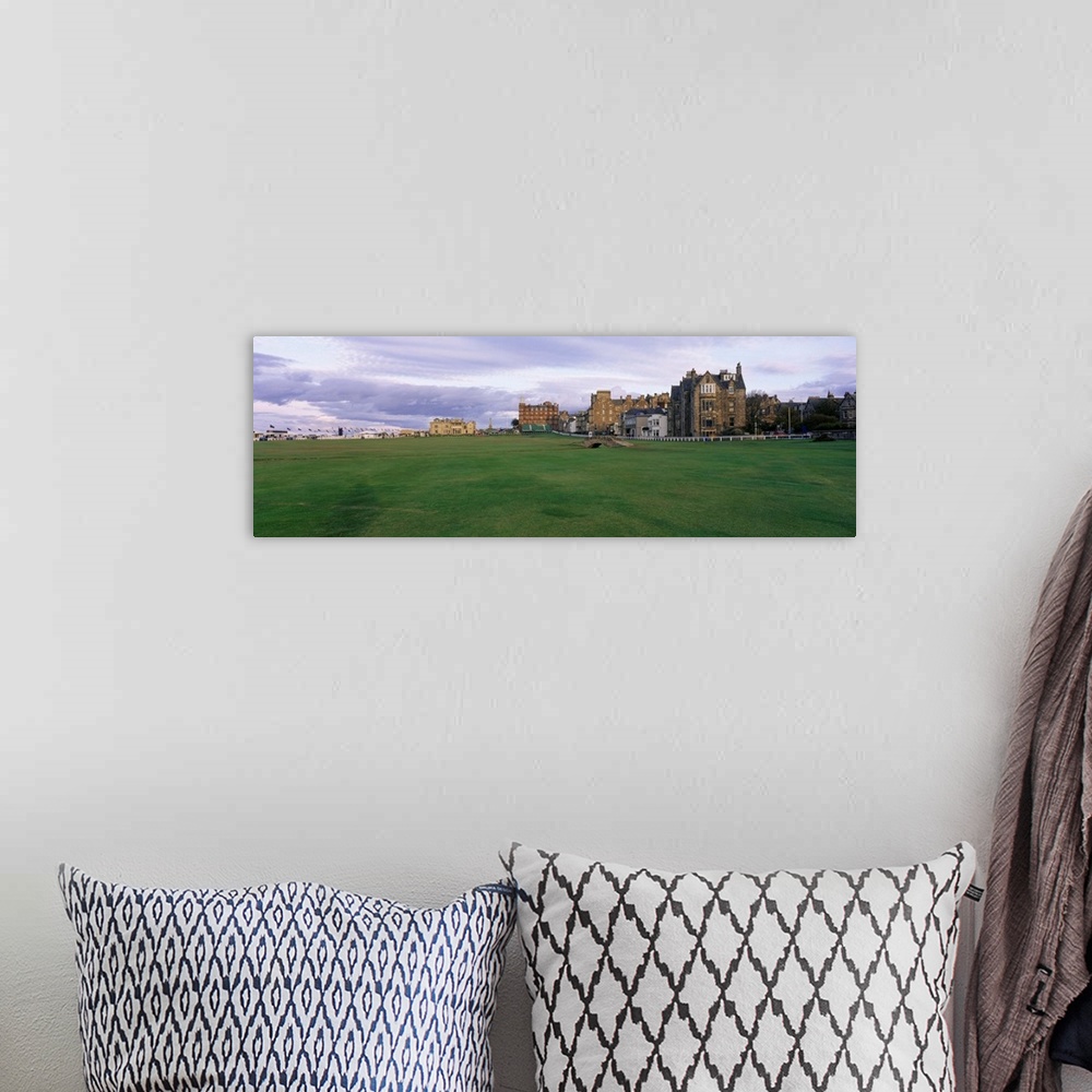 A bohemian room featuring Panoramic picture taken of buildings that are a part of a famous golf club in Scotland.