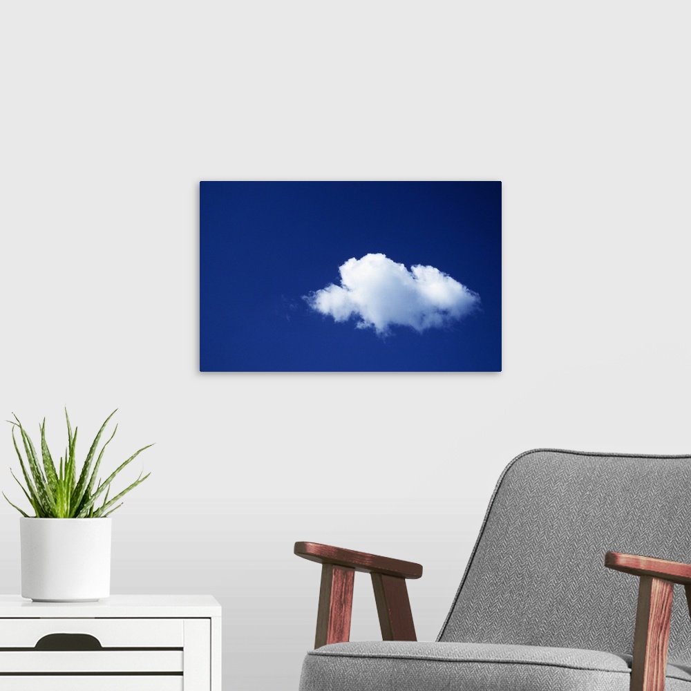 A modern room featuring Single white cloud, blue sky.