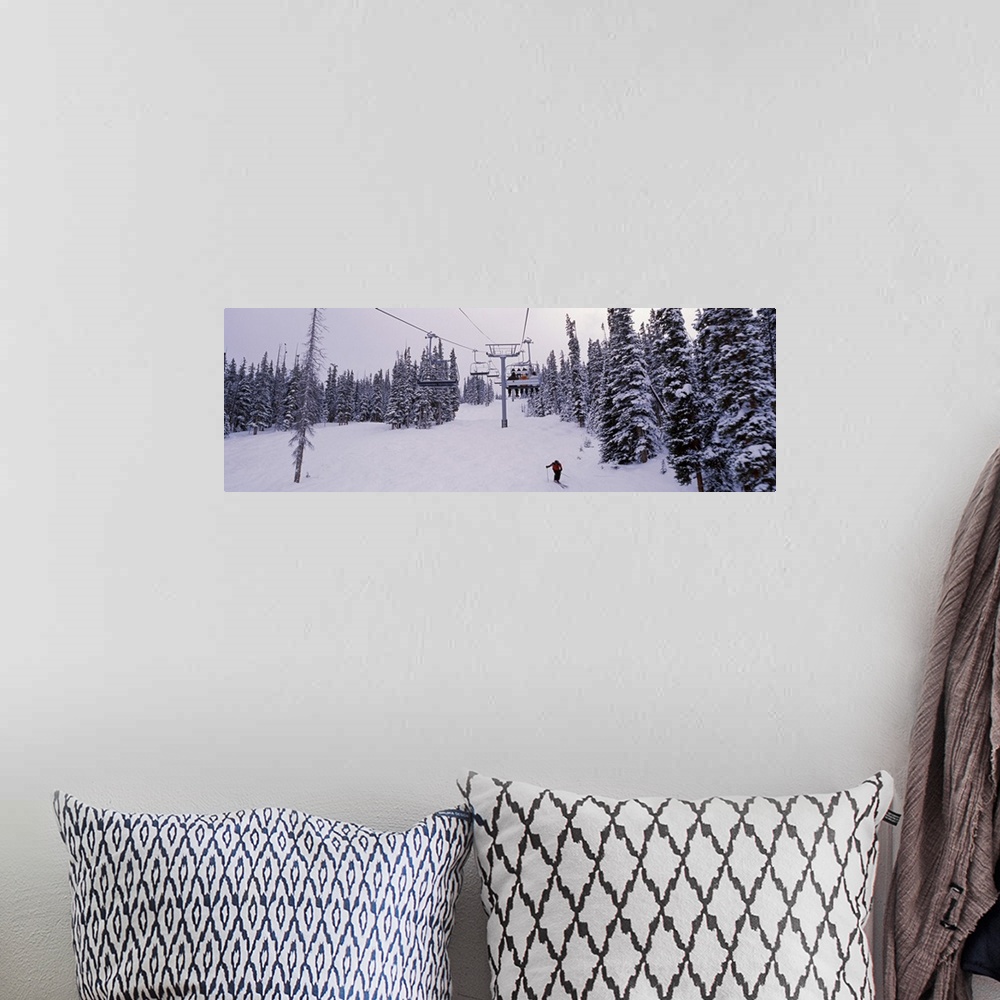 A bohemian room featuring Panoramic photograph on a giant canvas of a ski lift surrounded by snow covered trees, one skier ...
