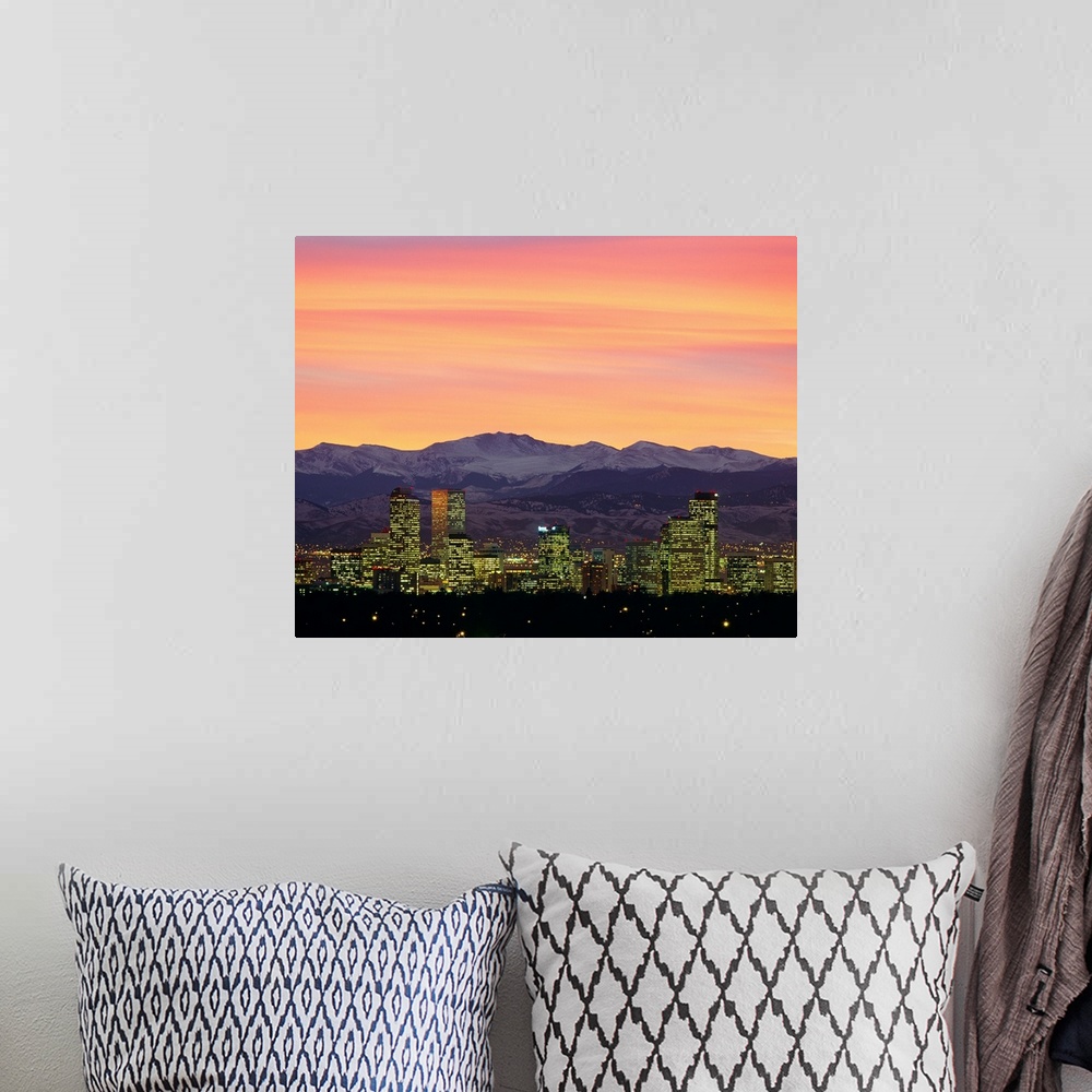 A bohemian room featuring Large photograph taken of the Denver, Colorado skyline at dusk.  The snow covered mountains in th...