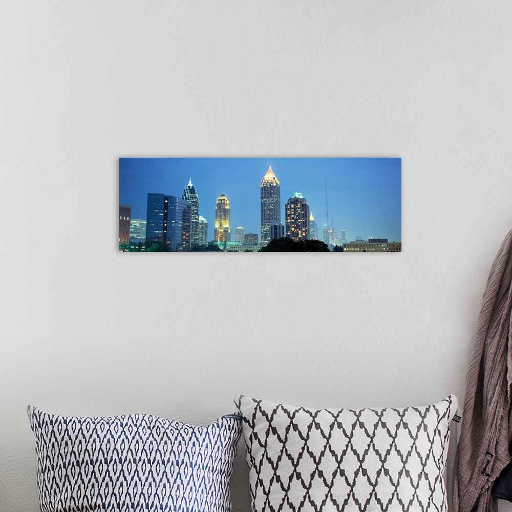 A bohemian room featuring The Atlanta skyline is illuminated and photographed in panoramic view.