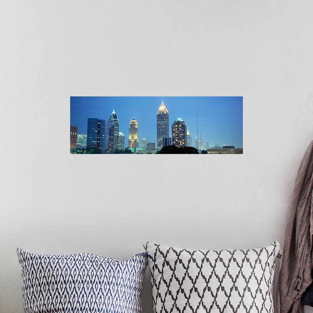 A bohemian room featuring The Atlanta skyline is illuminated and photographed in panoramic view.
