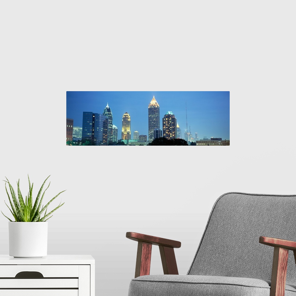 A modern room featuring The Atlanta skyline is illuminated and photographed in panoramic view.