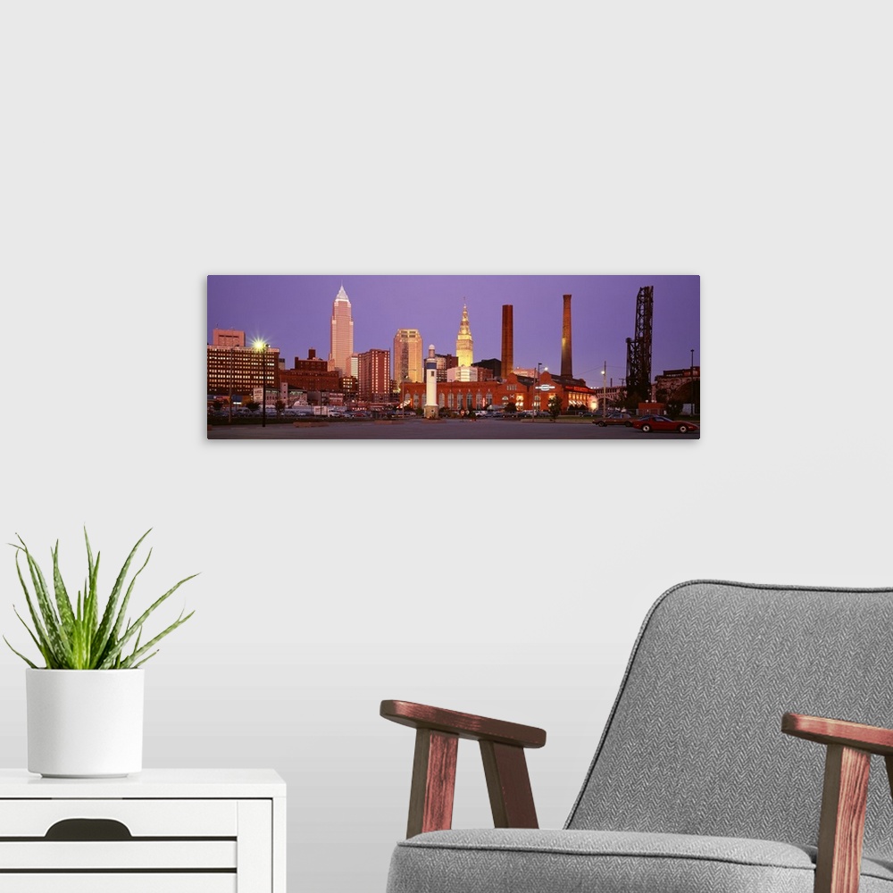 A modern room featuring Panoramic photograph of skyscrapers in Cleveland, Ohio, lit up at night.