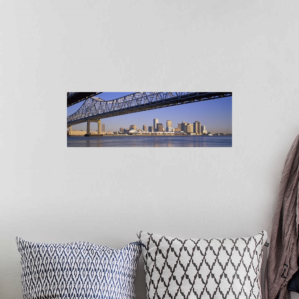 A bohemian room featuring Part of the New Orleans skyline is photographed from a distance below the Crescent City Connectio...