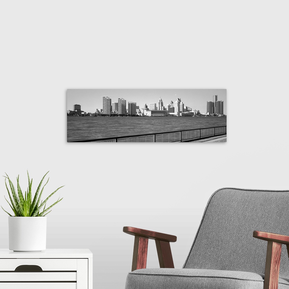 A modern room featuring This panoramic photograph is in black and white and taken of the Detroit skyline from across the ...