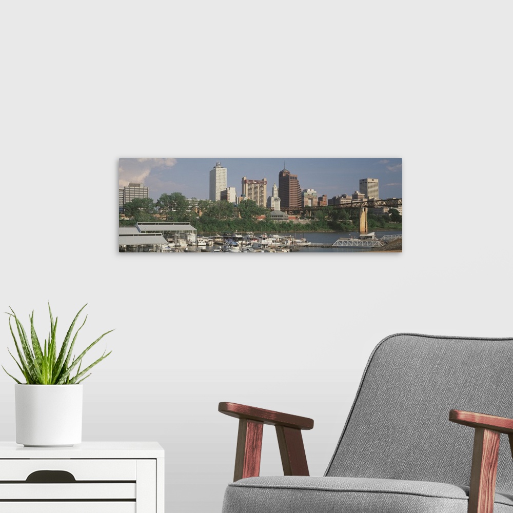 A modern room featuring A panoramic view of the Memphis, Tennessee skyline, including boats on the river.
