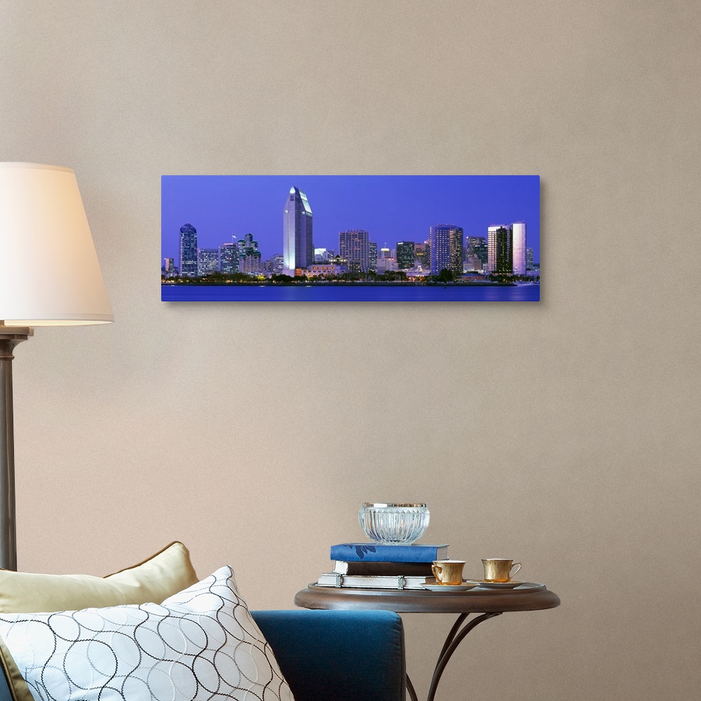 A traditional room featuring Skyscrapers in San Diego are illuminated and photographed in panoramic view from across a body of...