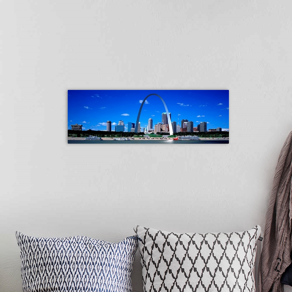 A bohemian room featuring Panoramic photograph of downtown district skyline and iconic arch on a sunny day with waterfront.