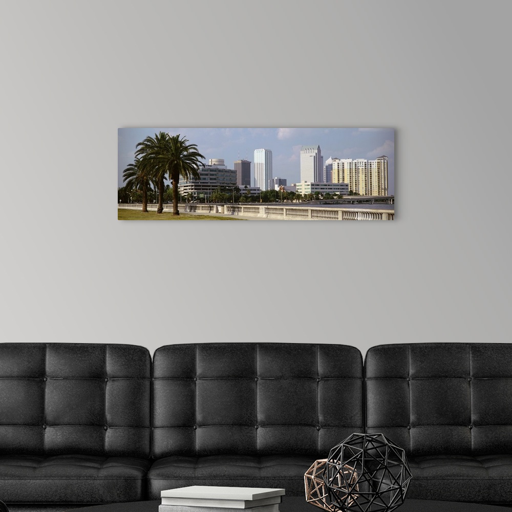 A modern room featuring The skyline in Tampa is photographed from across the body of water that sits in front of it. Larg...