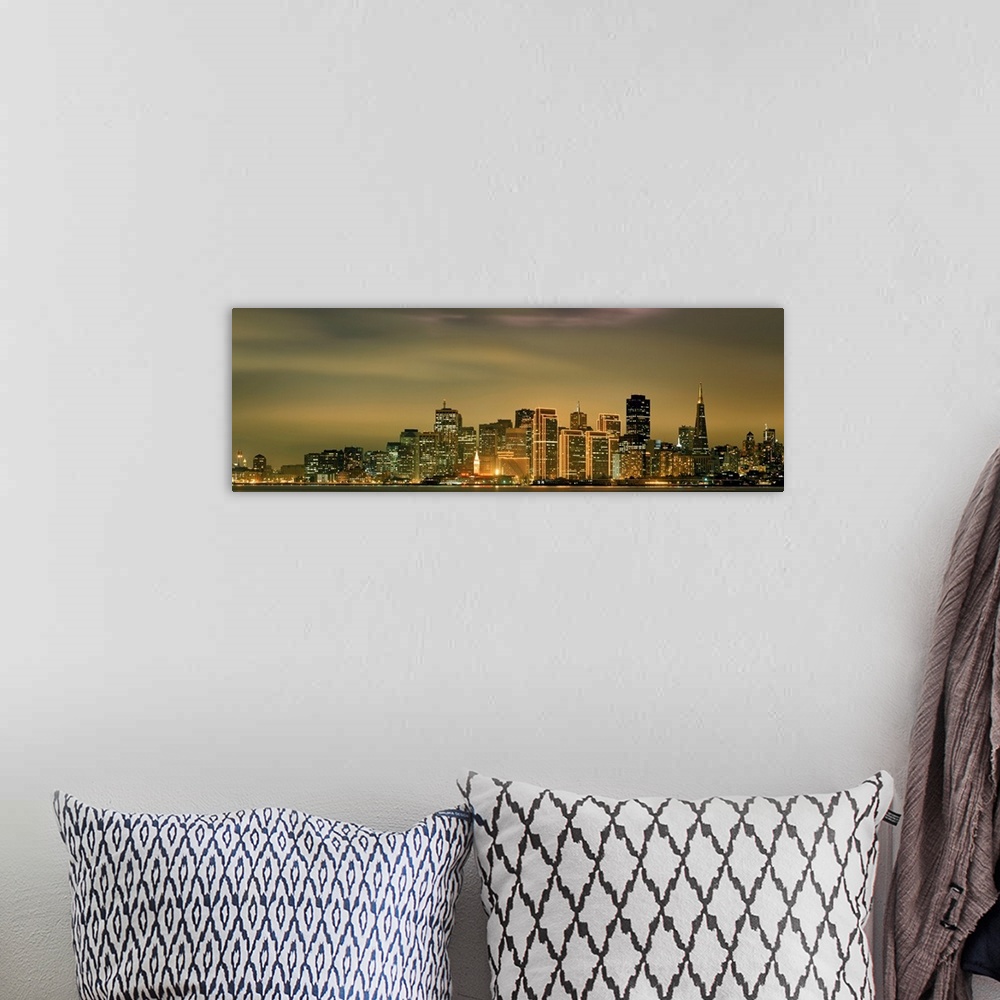 A bohemian room featuring Large panoramic image of the San Francisco skyline lit up at dusk.