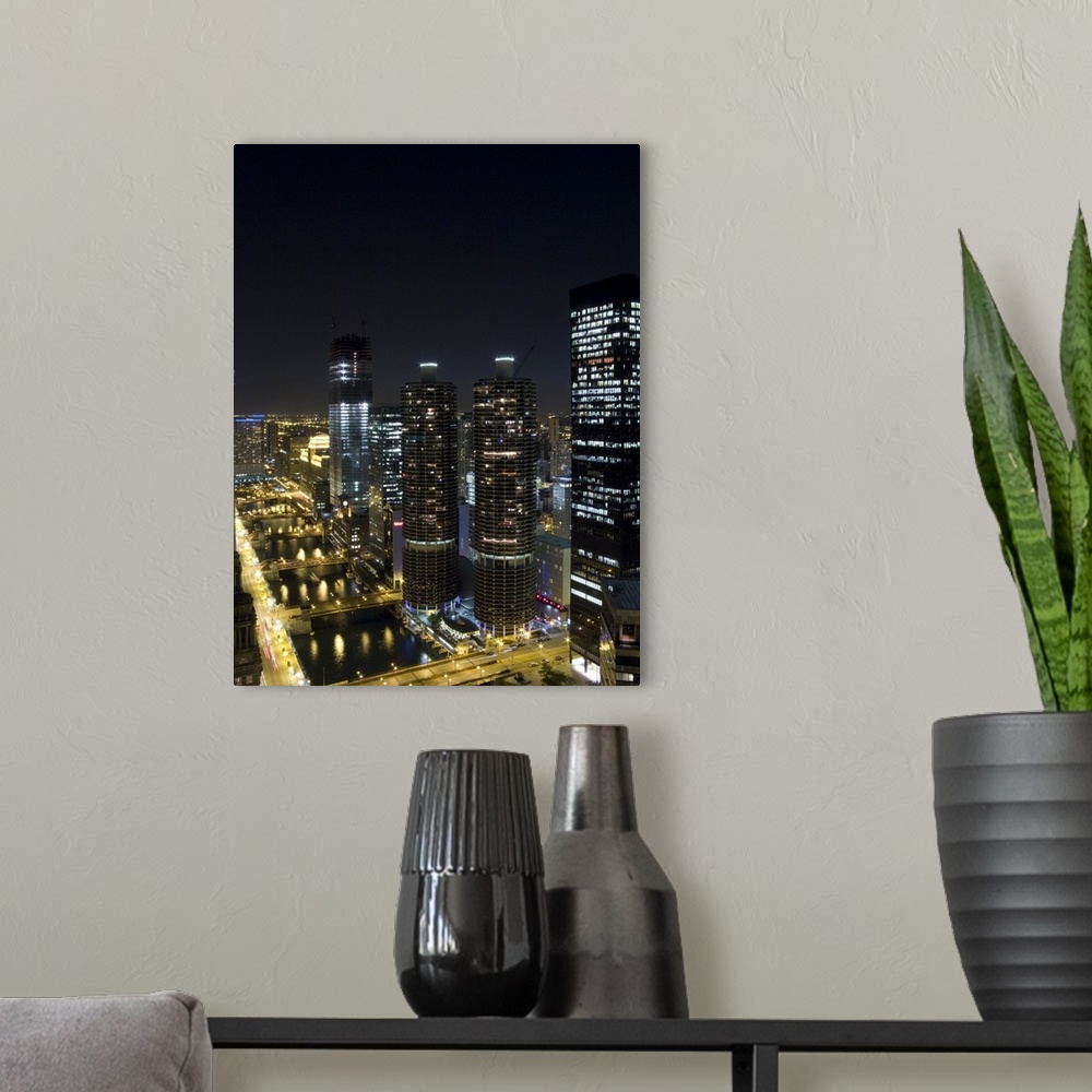 A modern room featuring Skyscrapers along the Chicago River lit up at night, Magnificent Mile, Michigan Avenue, Chicago, ...