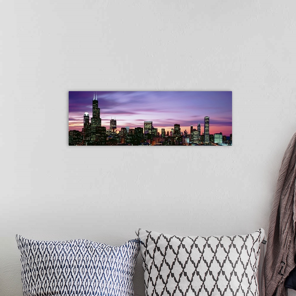 A bohemian room featuring This is a panoramic photograph of a sunset behind the shining city skyline in the Midwest.