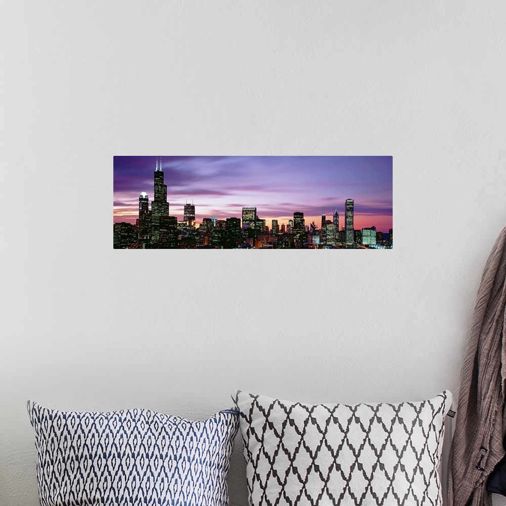 A bohemian room featuring This is a panoramic photograph of a sunset behind the shining city skyline in the Midwest.