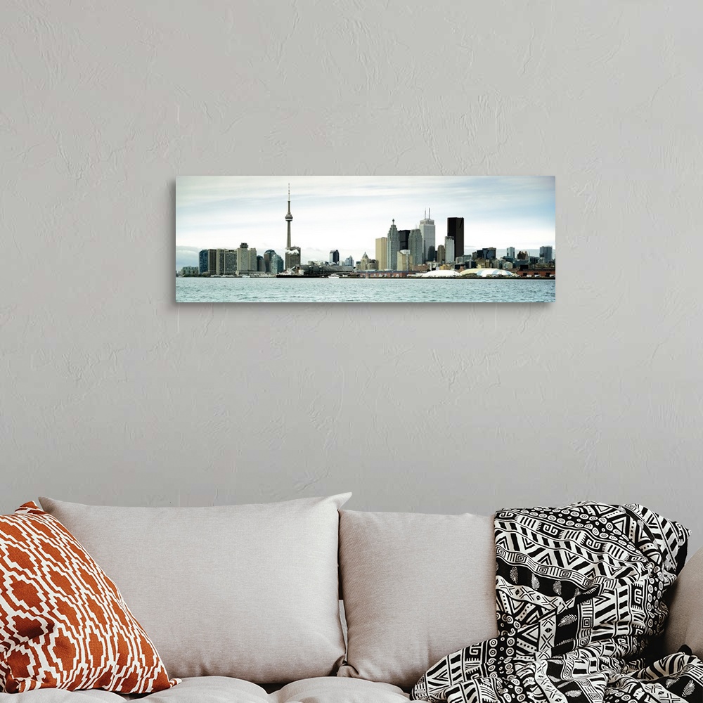 A bohemian room featuring This decorative accent is a panoramic photograph of the downtown city skyline taken from across t...