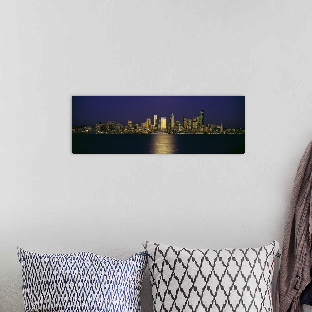 A bohemian room featuring Wide angle, distant photograph of the Seattle skyline, lit at night, over Elliott Bay in Washington.