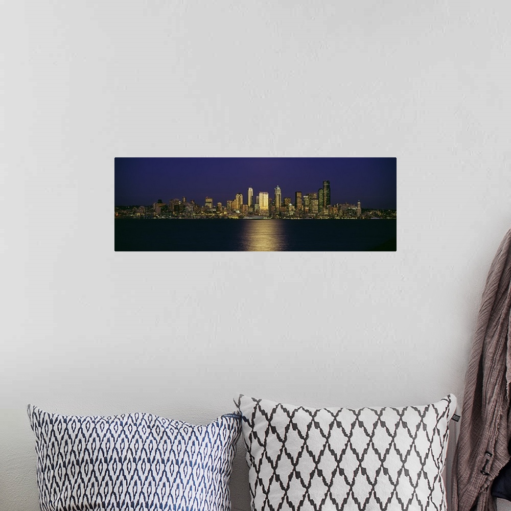A bohemian room featuring Wide angle, distant photograph of the Seattle skyline, lit at night, over Elliott Bay in Washington.