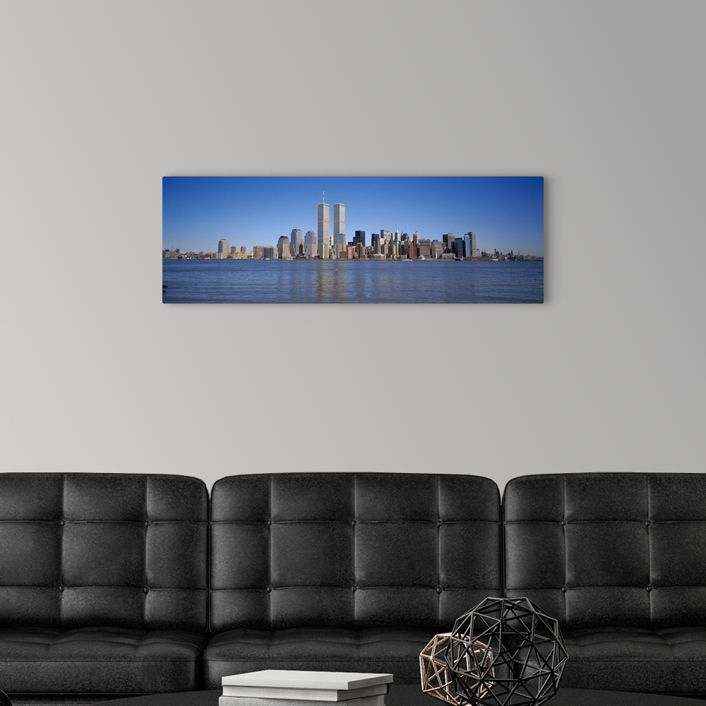 A modern room featuring Panoramic, distant photograph of the New York City skyline including the World Trade Center, refl...