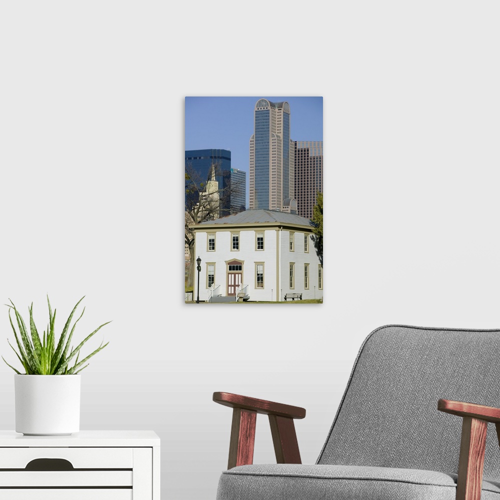 A modern room featuring Skyscrapers behind an old house, Old City Park, Dallas, Texas