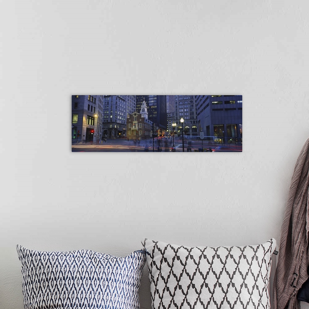 A bohemian room featuring Panoramic photo art of a downtown area with tall buildings illuminated at night.