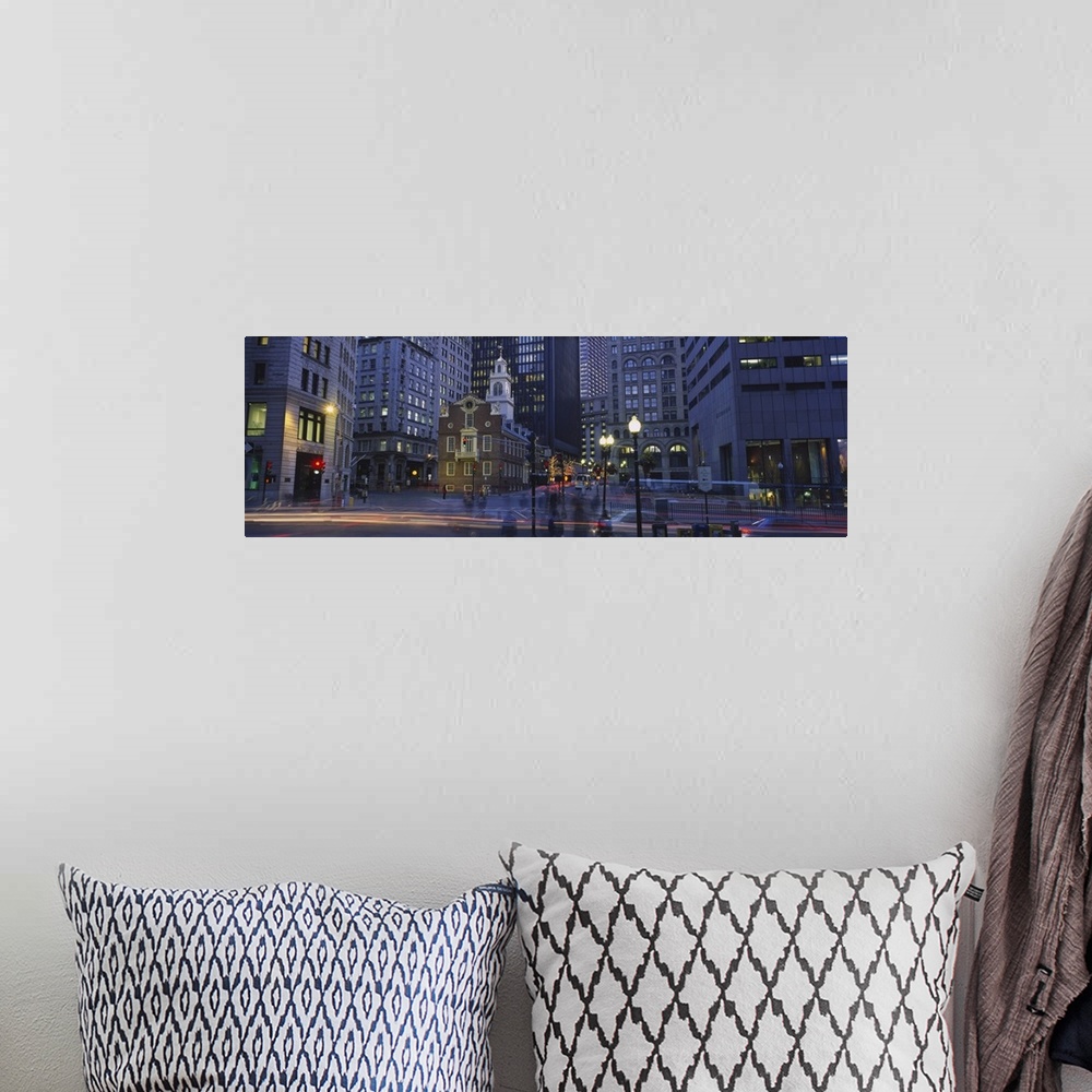 A bohemian room featuring Panoramic photo art of a downtown area with tall buildings illuminated at night.