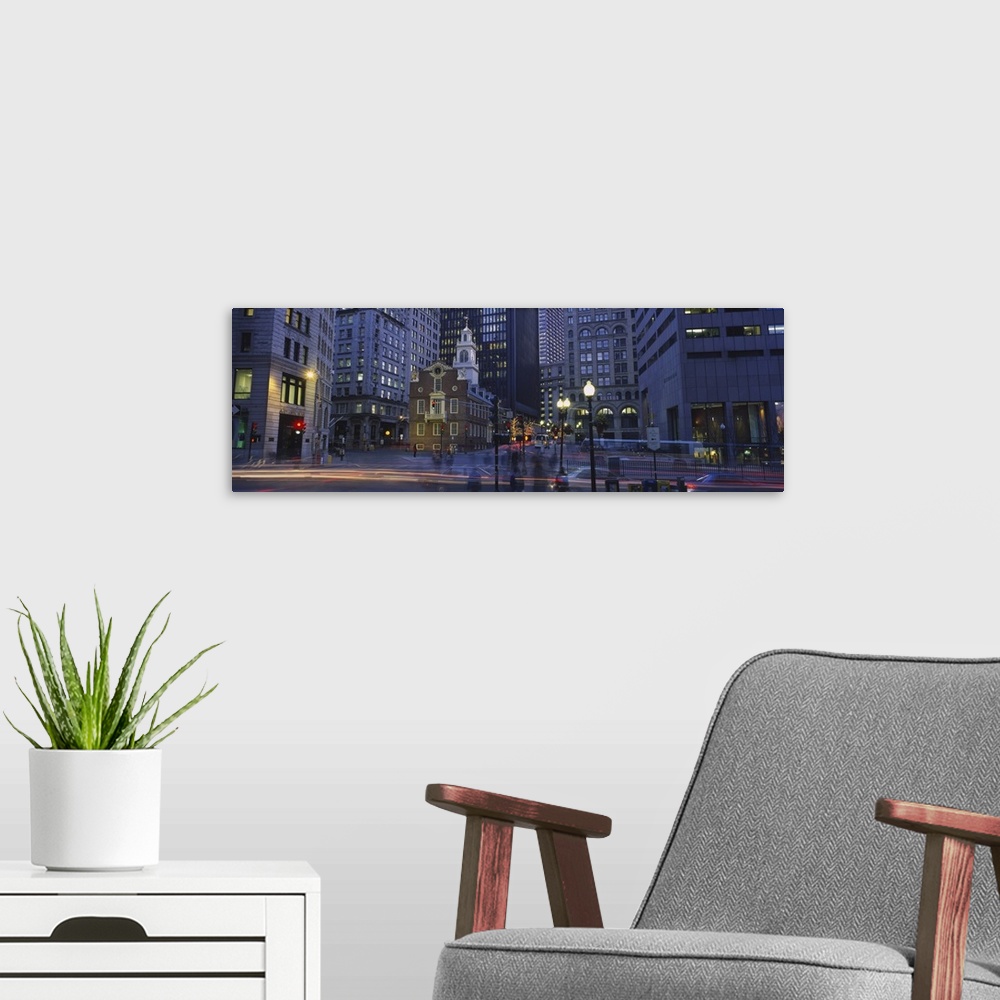 A modern room featuring Panoramic photo art of a downtown area with tall buildings illuminated at night.
