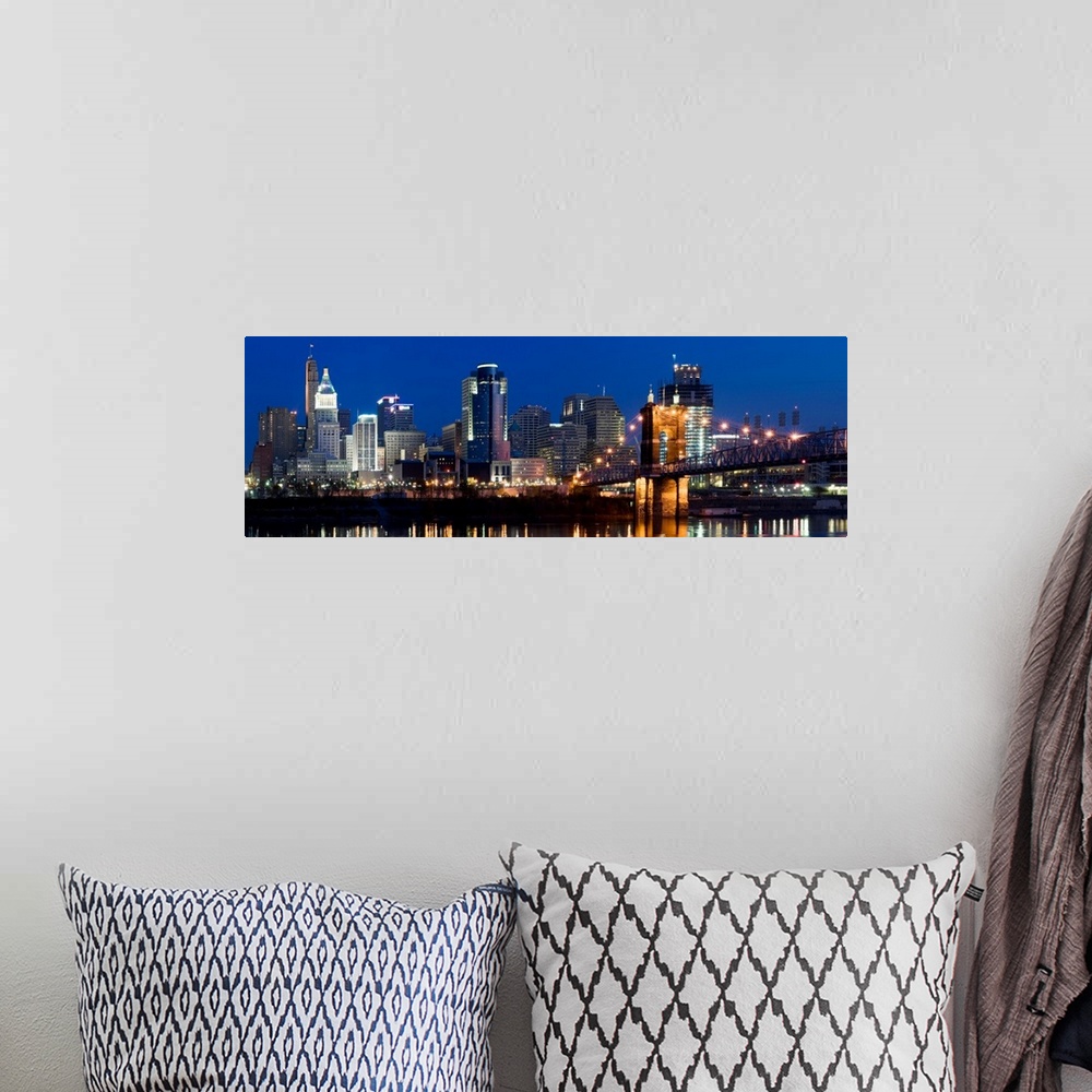 A bohemian room featuring Tall buildings reflecting in the water of the Ohio River in this panoramic landscape canvas.