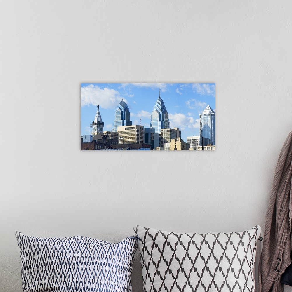 A bohemian room featuring An urban landscape photograph of the city skyline taken from ground level.