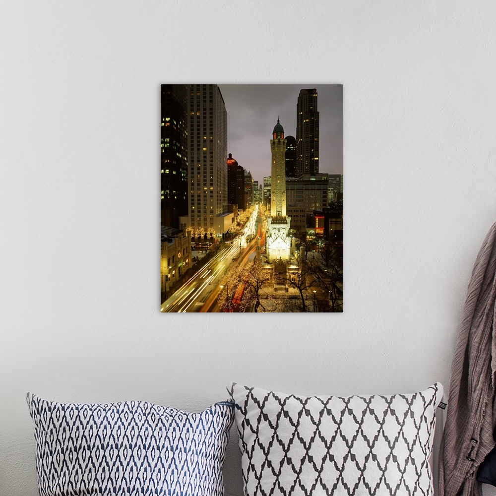 A bohemian room featuring Huge photograph looks down a busy avenue flooded with people and cars, while a variety of tall bu...
