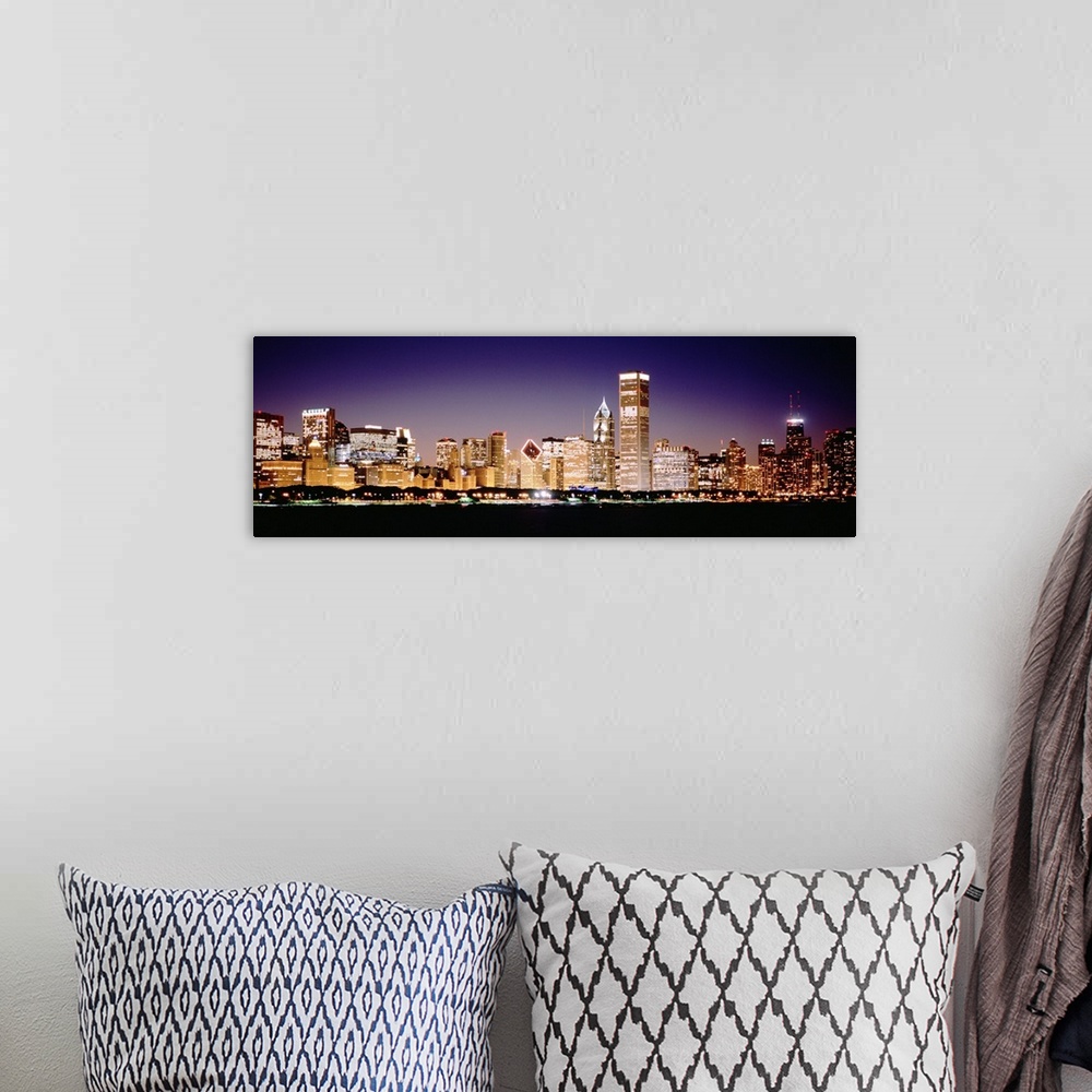 A bohemian room featuring Panoramic photograph shows the intensely vibrant lights of skyscrapers that fill the busy skyline...