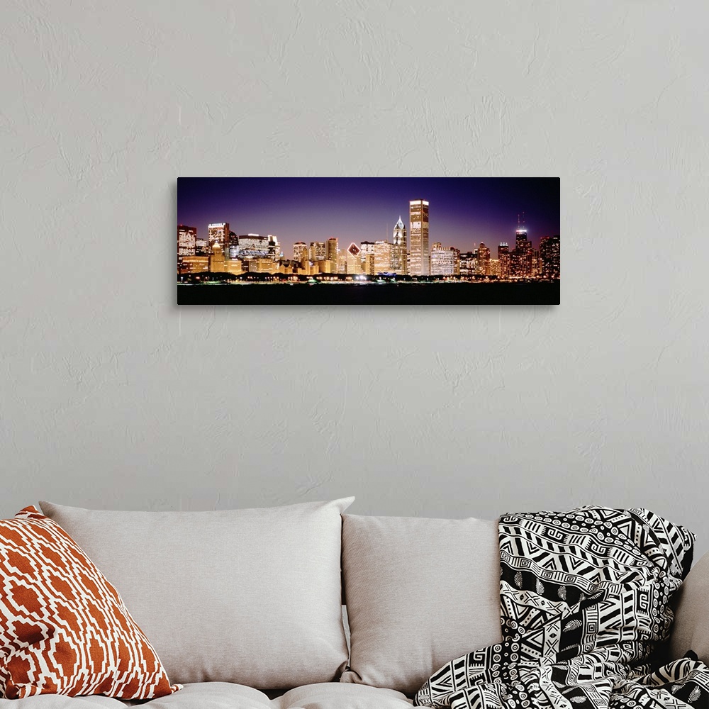 A bohemian room featuring Panoramic photograph shows the intensely vibrant lights of skyscrapers that fill the busy skyline...