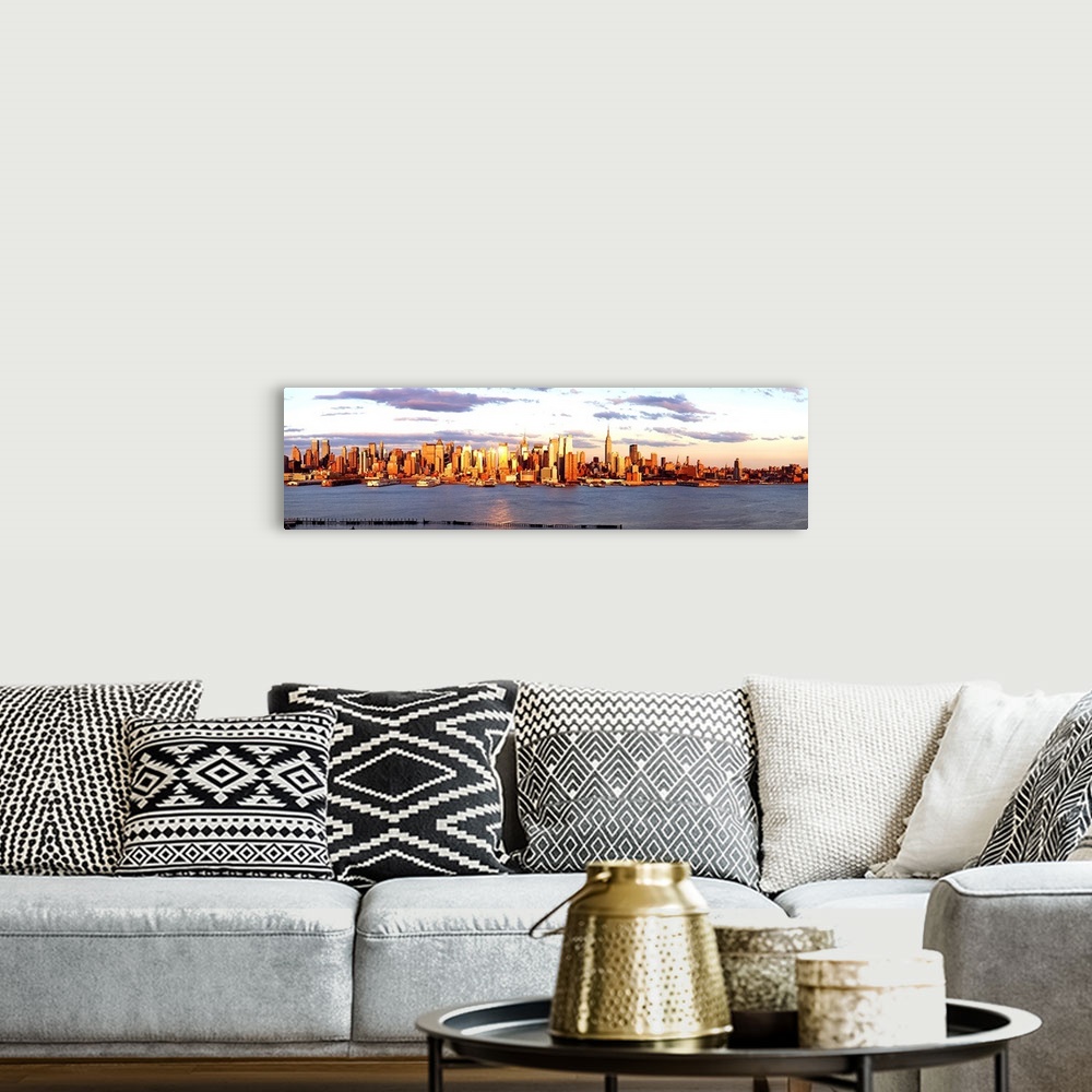 A bohemian room featuring Panoramic photograph of the distant Manhattan skyline at the waters edge, with golden skyscrapers...