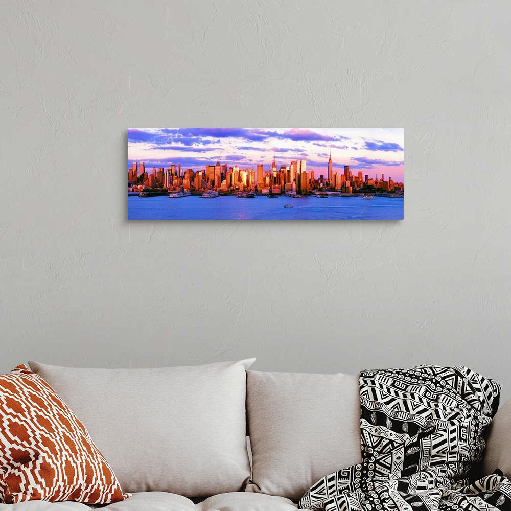 A bohemian room featuring Panoramic photograph of the water in front of the New York City skyline, beneath a vibrant, partl...