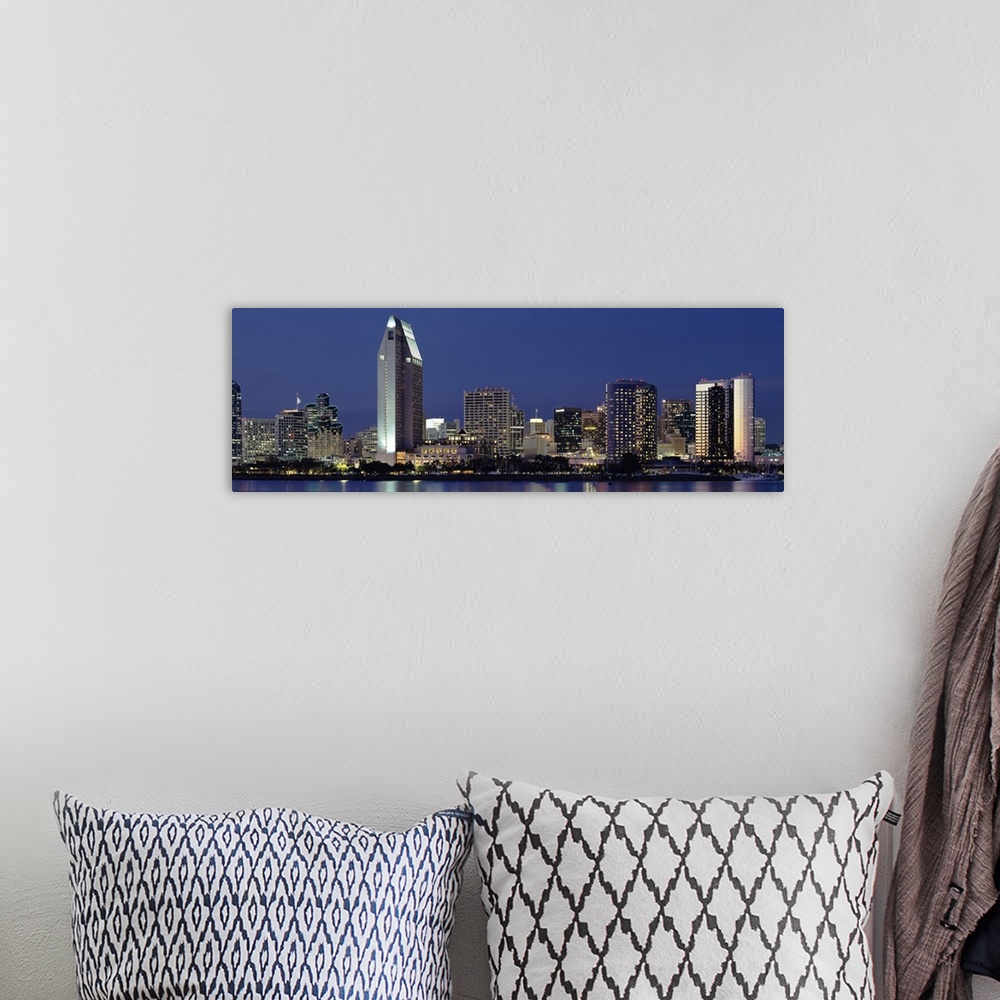 A bohemian room featuring This large panoramic photograph is of the San Diego skyline at night with all of the buildings li...