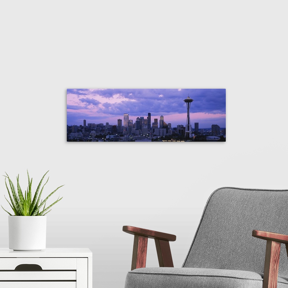 A modern room featuring Panoramic cityscape photo of a major Pacific Northwest city with the Space Needle on the right.