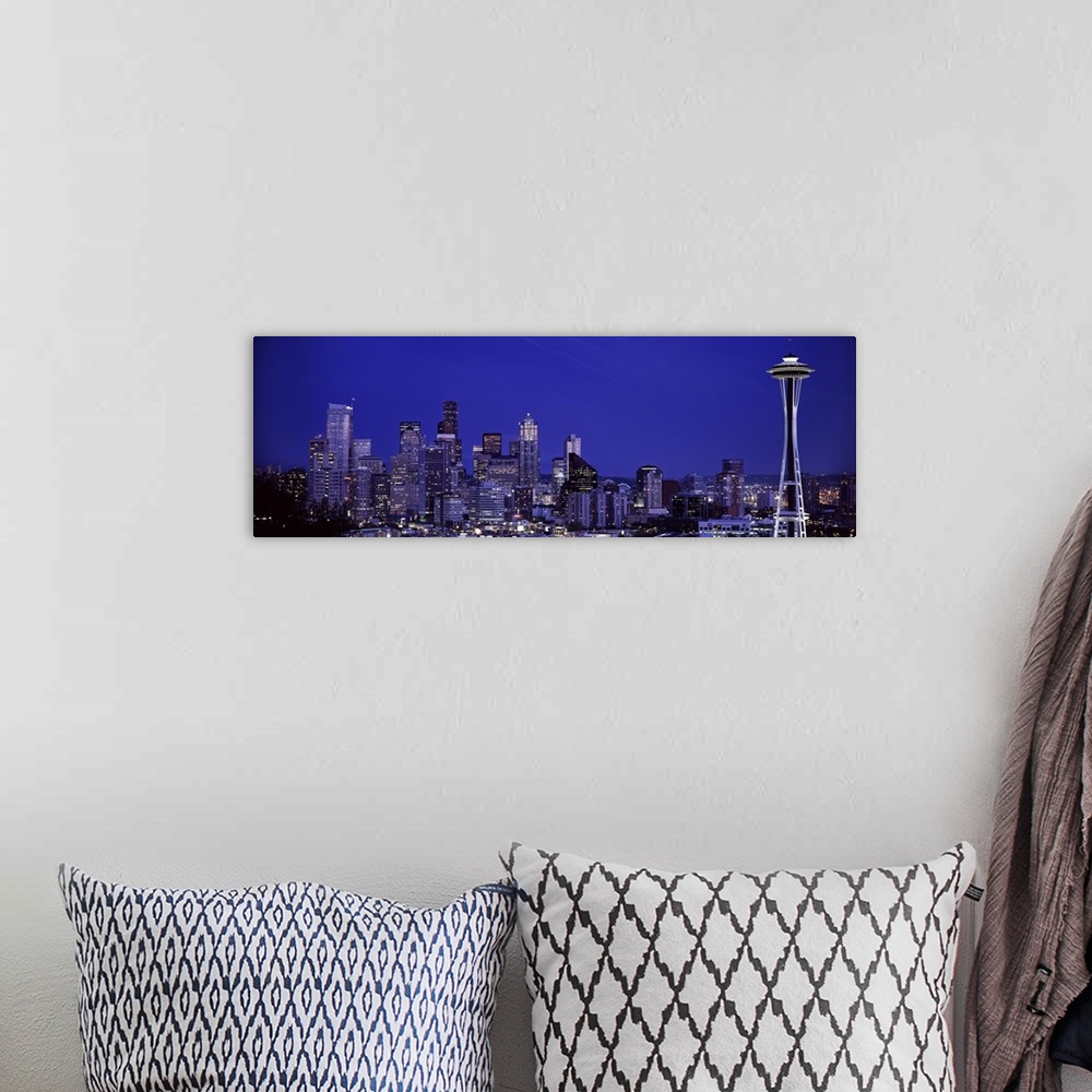 A bohemian room featuring Panoramic photograph of skyline at night with buildings lit up.  Iconic buildings such as the Spa...