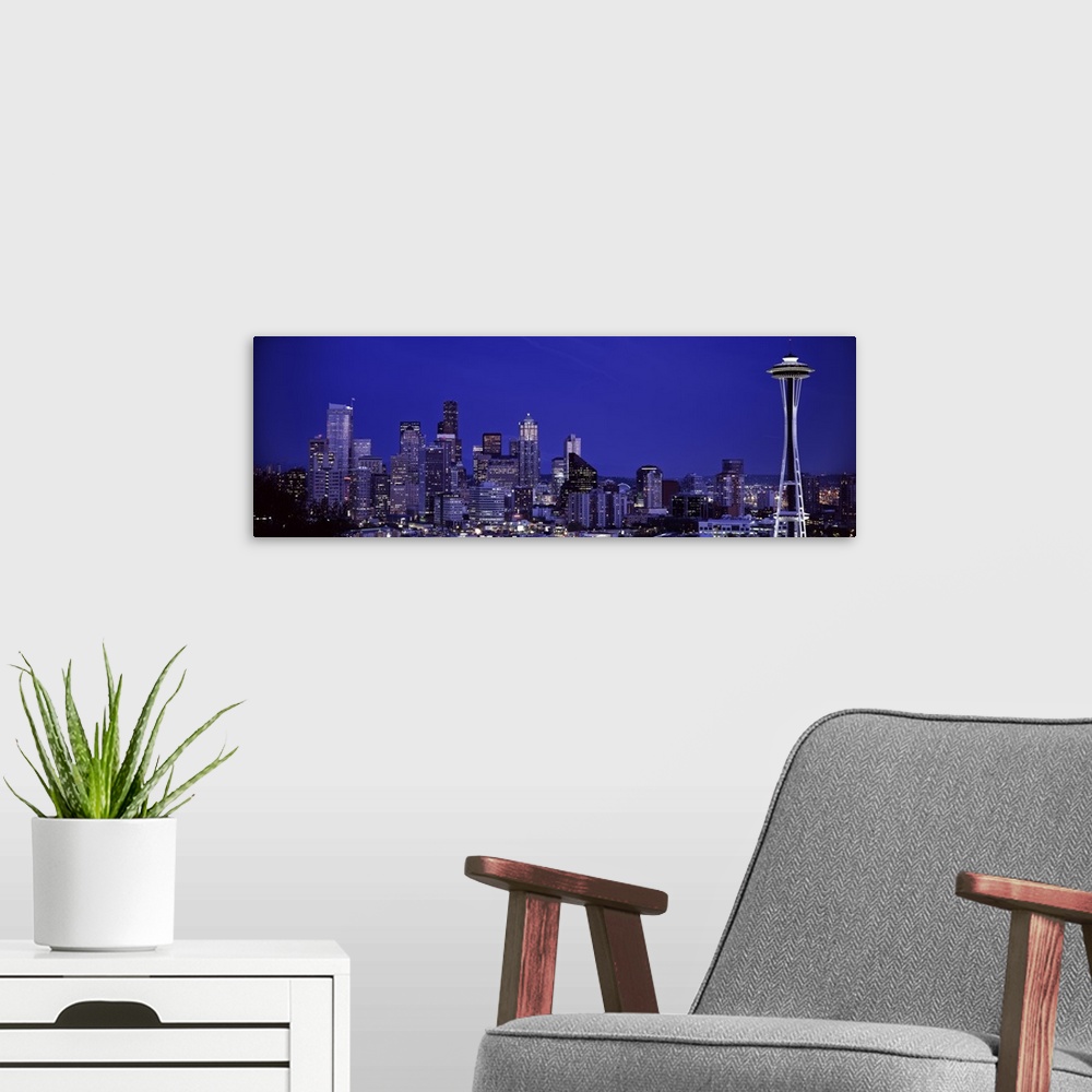 A modern room featuring Panoramic photograph of skyline at night with buildings lit up.  Iconic buildings such as the Spa...