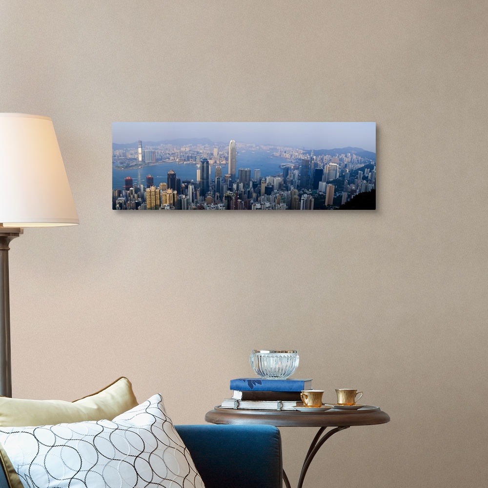 A traditional room featuring Wide angel, aerial photograph of large buildings in Hong Kong, China, surrounding Victoria Harbour.