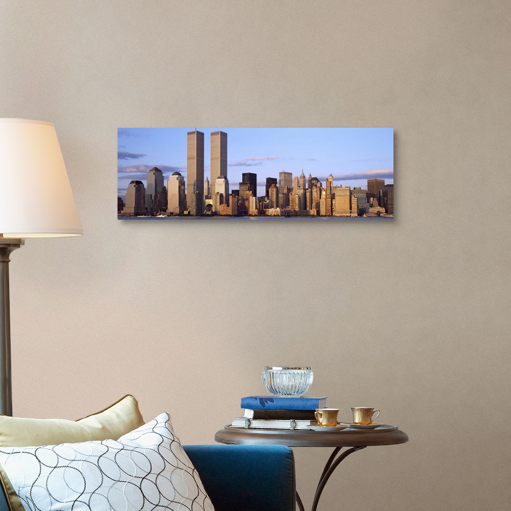 A traditional room featuring The Manhattan skyline is photographed in panoramic view with the World Trade Center buildings sta...