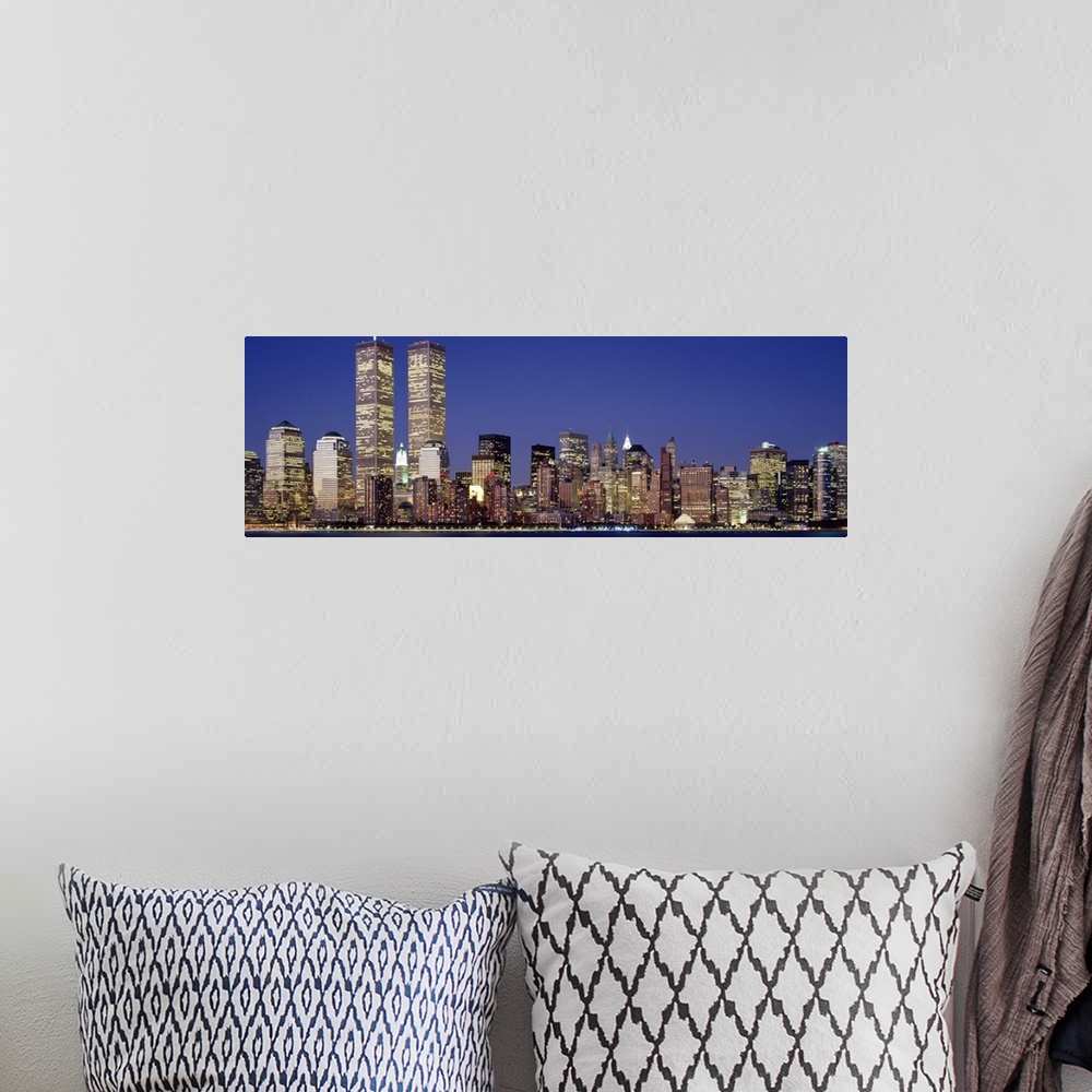 A bohemian room featuring Panoramic photograph displays the nighttime skyline of a busy city within the Northeastern United...