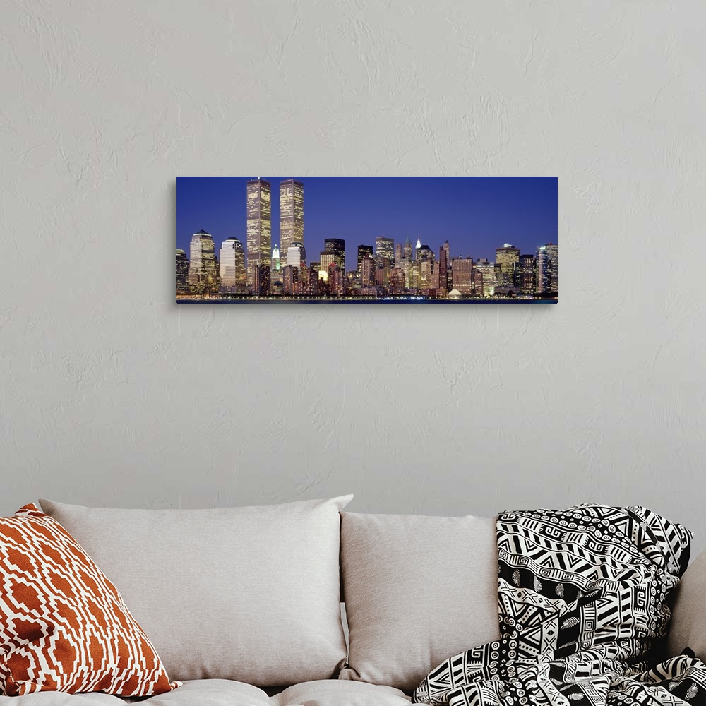 A bohemian room featuring Panoramic photograph displays the nighttime skyline of a busy city within the Northeastern United...