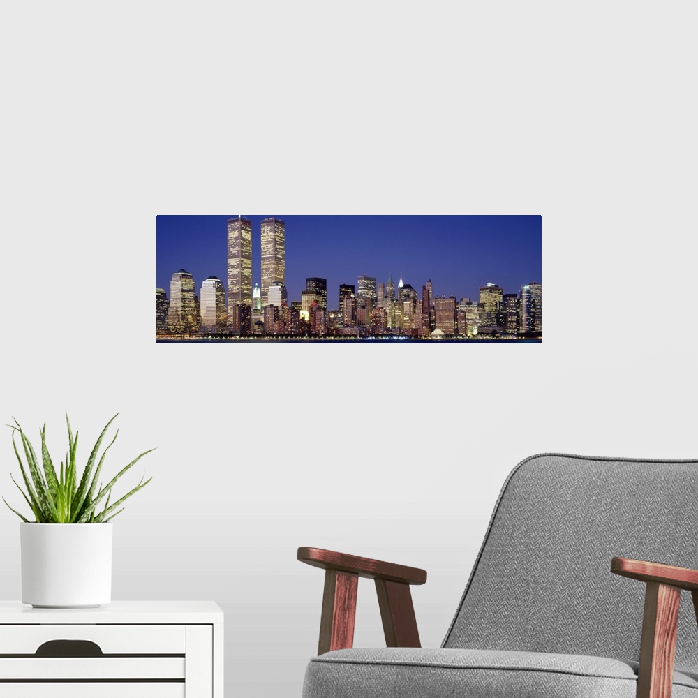 A modern room featuring Panoramic photograph displays the nighttime skyline of a busy city within the Northeastern United...